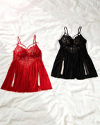 Two lace babydoll chemises laid flat on a white wrinkled fabric background: one red on the left and one black on the right. Both have lace cups, thin straps, and a sheer gathered skirt.