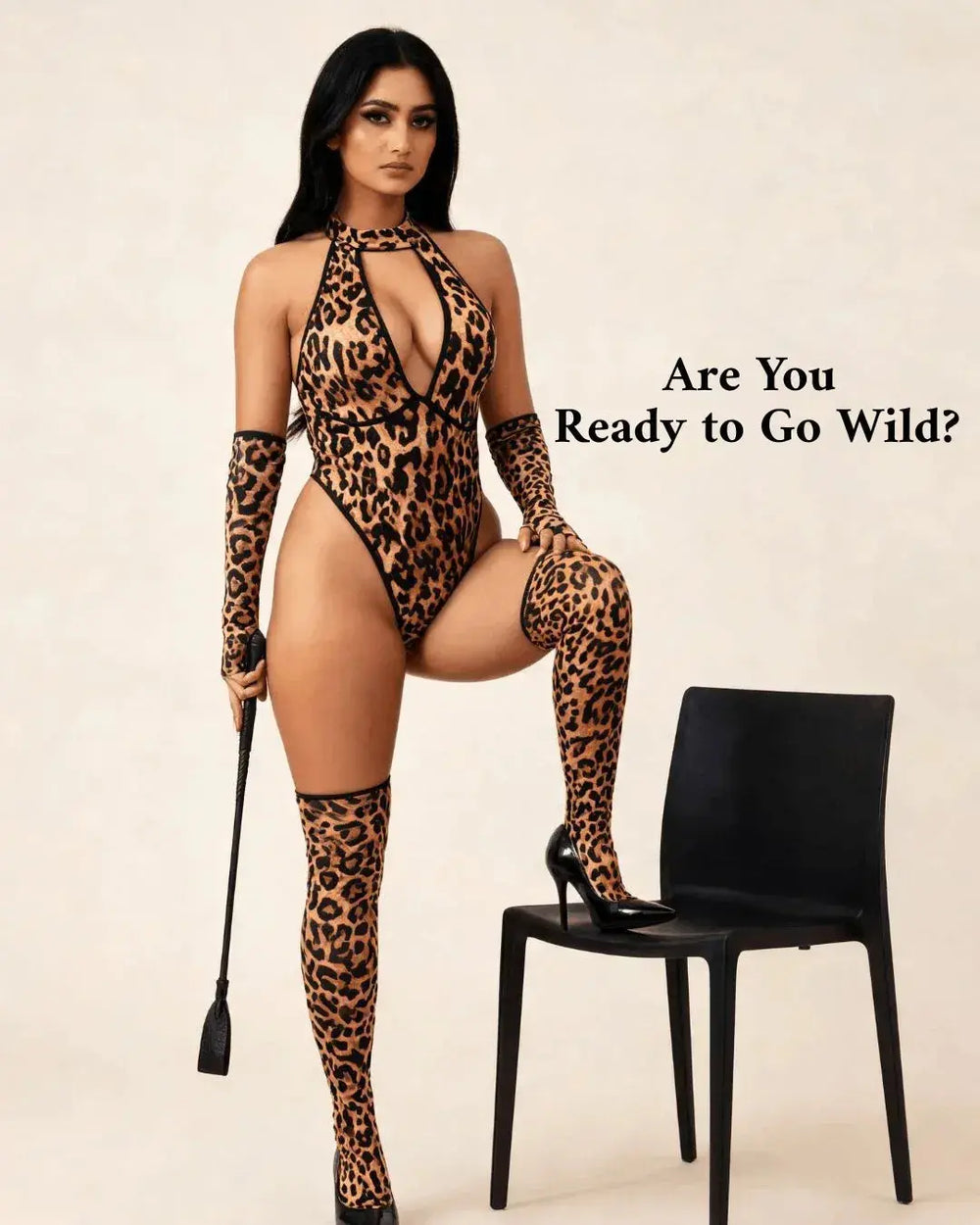 A woman modeling a leopard-print bodysuit, matching thigh-high stockings, and a riding crop against a plain beige background, with the text 'Are You Ready to Go Wild?' on the right and a black chair beside her.