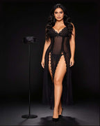 A woman models a black sheer lingerie set with lace trim and a long matching robe against a dark studio background. A black garment stand is positioned to her left.